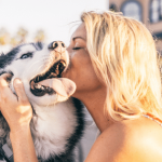 woman kissing dog